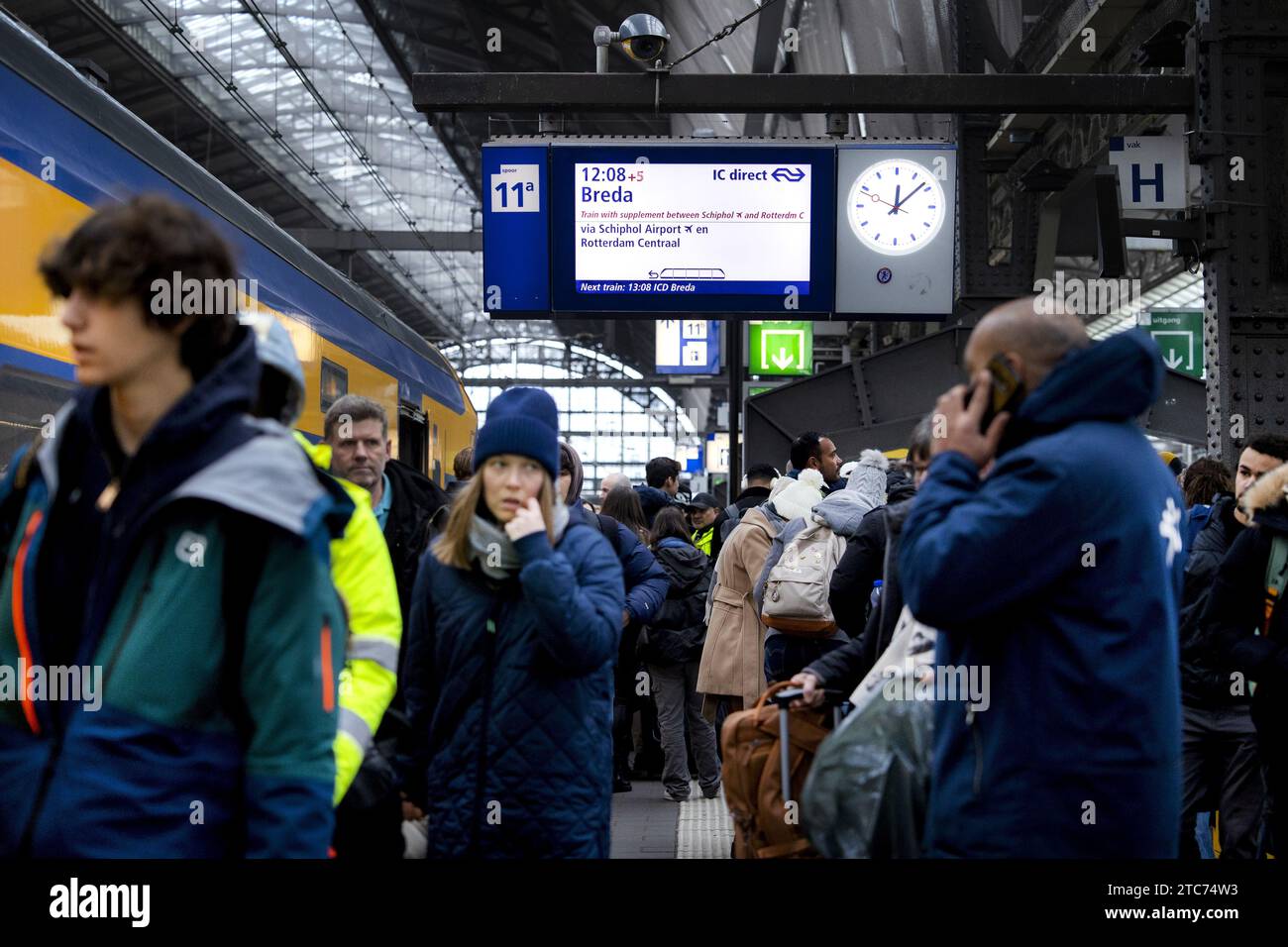 AMSTERDAM - Travelers at Amsterdam Central station. The new NS timetable has come into effect. For example, more intercity trains run between the major cities and the Intercity Direct between Amsterdam and Breda runs all day long. ANP RAMON VAN FLYMEN netherlands out - belgium out Stock Photo