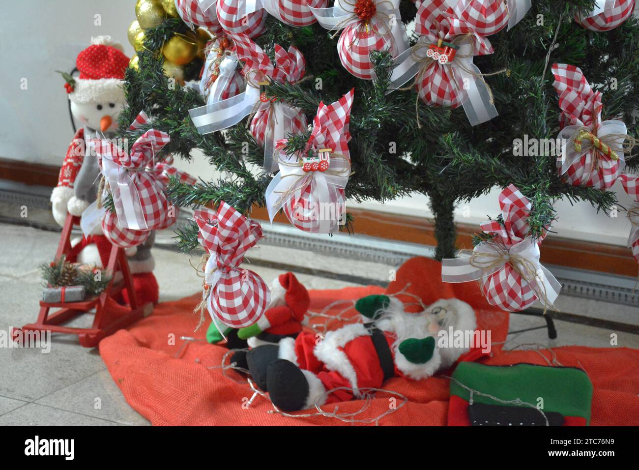 Christmas tree base with golden balls and Santa Claus. Brazil Stock Photo