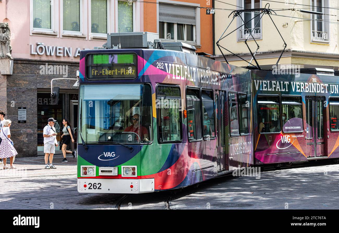 Strassenbahn Eine Strassenbahn der Linie 2 ist in den Strassen von Freiburg im Breisgau unterwegs. Das Tram trägt Werbung, dass die Vielfalt die Stadt verbindet. Freiburg im Breisgau, Deutschland, 07.08.2022 *** Streetcar A streetcar on line 2 is on the streets of Freiburg im Breisgau The streetcar carries advertising that diversity connects the city Freiburg im Breisgau, Germany, 07 08 2022 Stock Photo