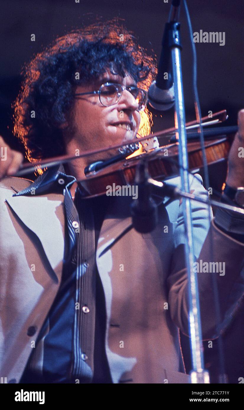 Musician David Bromberg playing his violin on stage in Central Park in