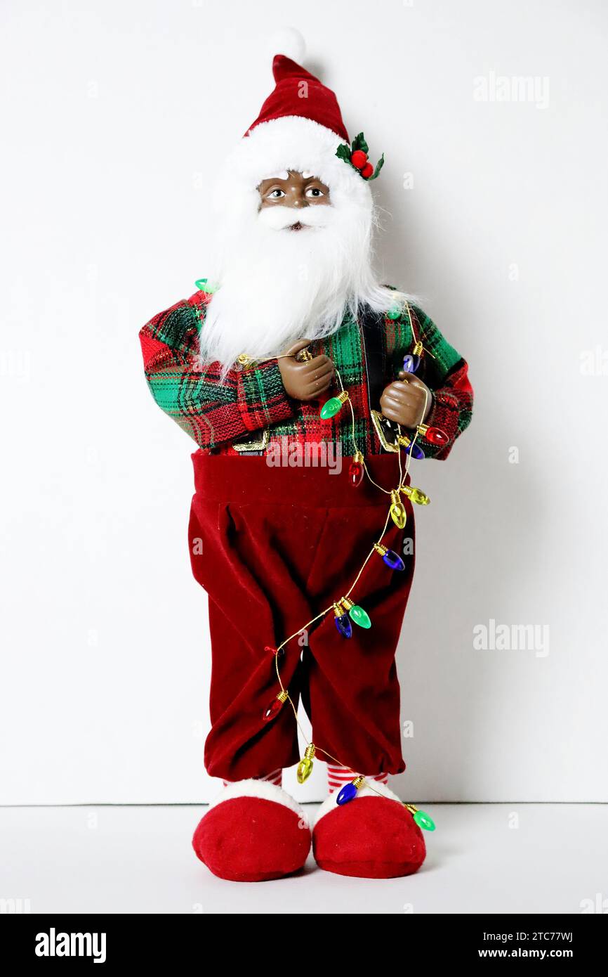 An African-American Santa Claus toy standing against a white background Stock Photo