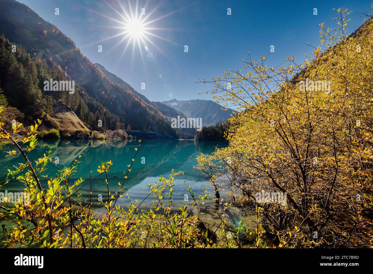 A beautiful sunny day with a serene blue lake and a clear blue sky ...