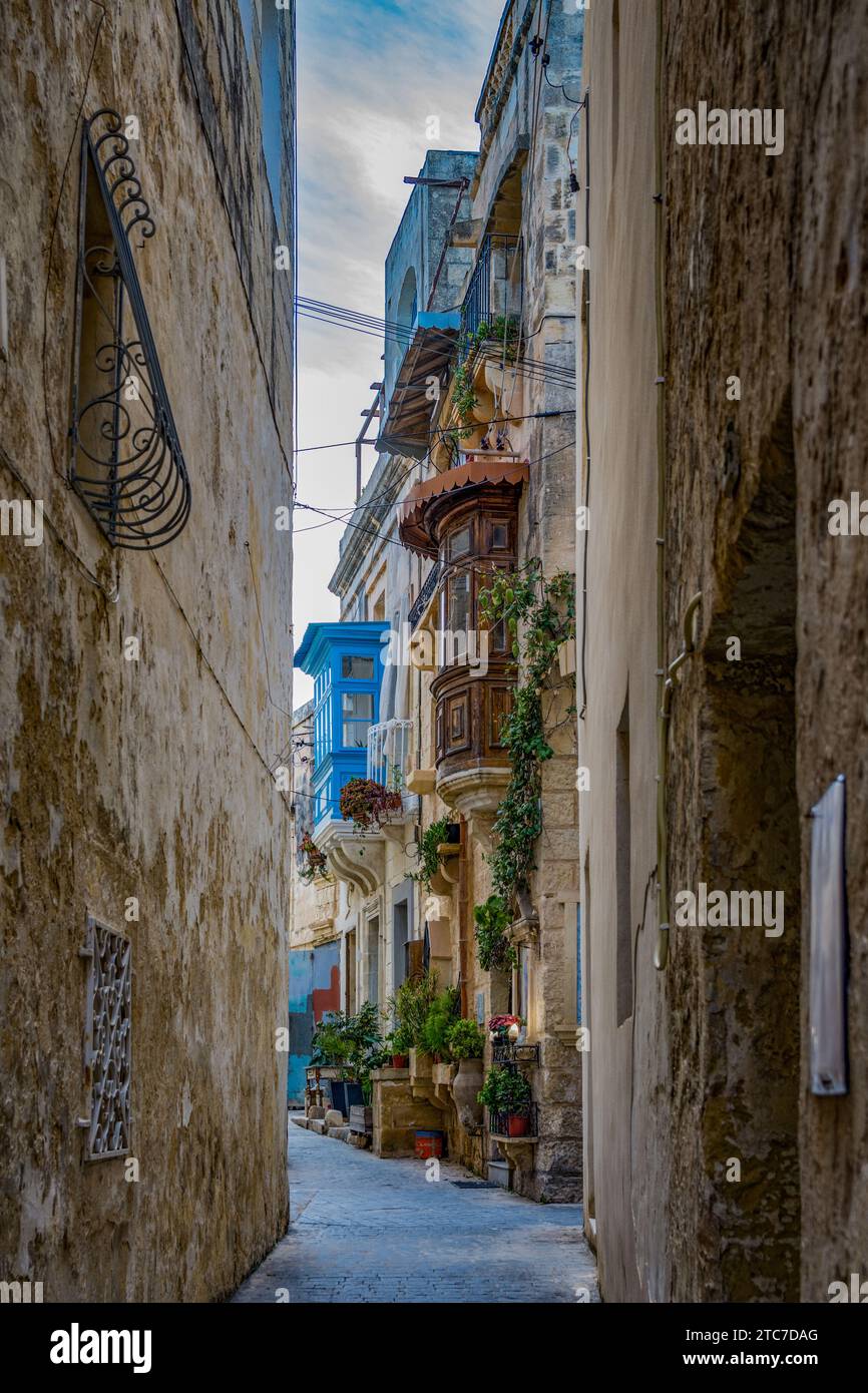 Characteristic Maltese alleyway with colorful balconies in Rabat village Stock Photo