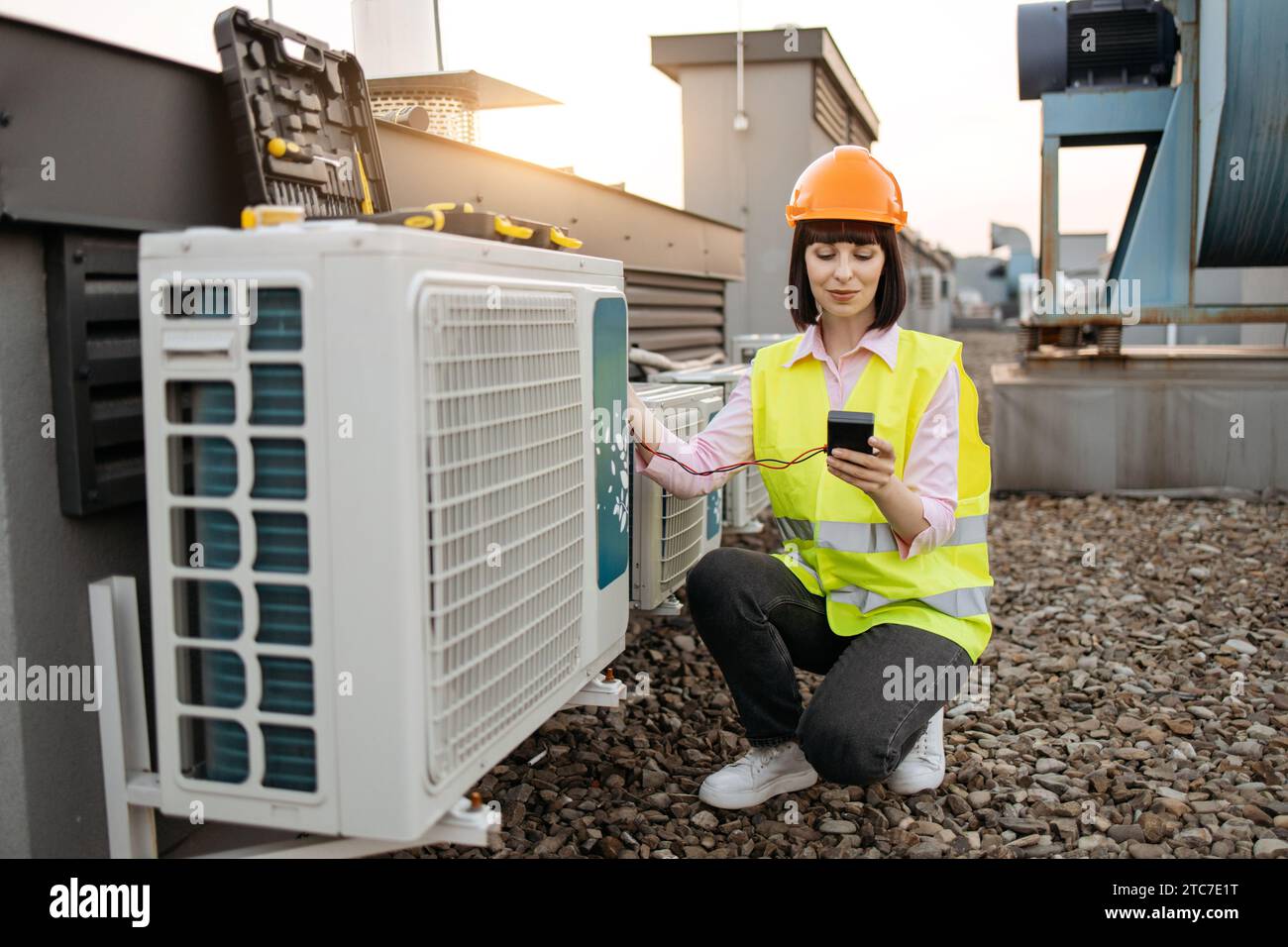 Woman using checking tool for work with air conditioner Stock Photo