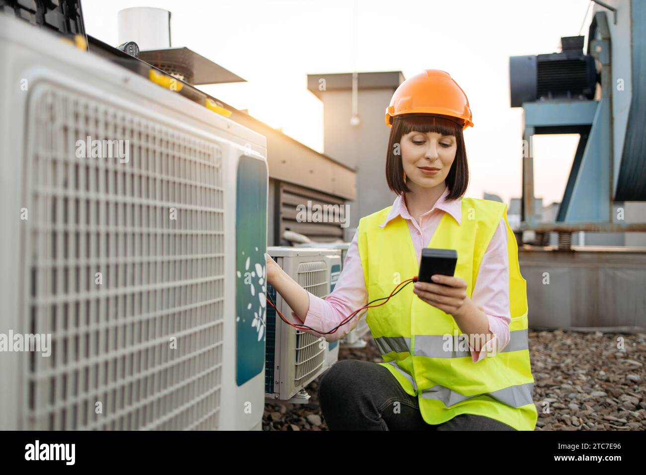 Woman using checking tool for work with air conditioner Stock Photo