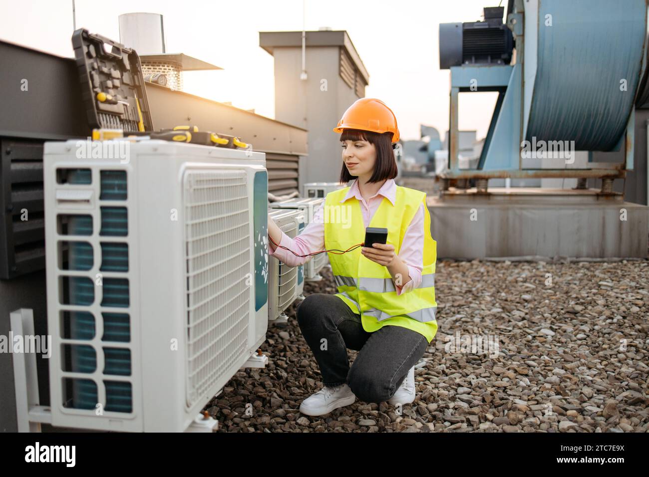 Woman using checking tool for work with air conditioner Stock Photo
