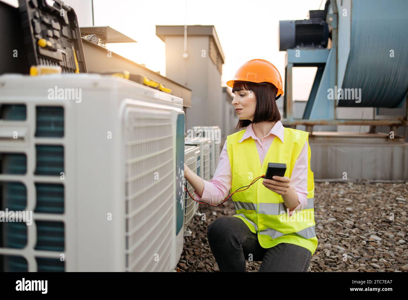 Woman using checking tool for work with air conditioner Stock Photo
