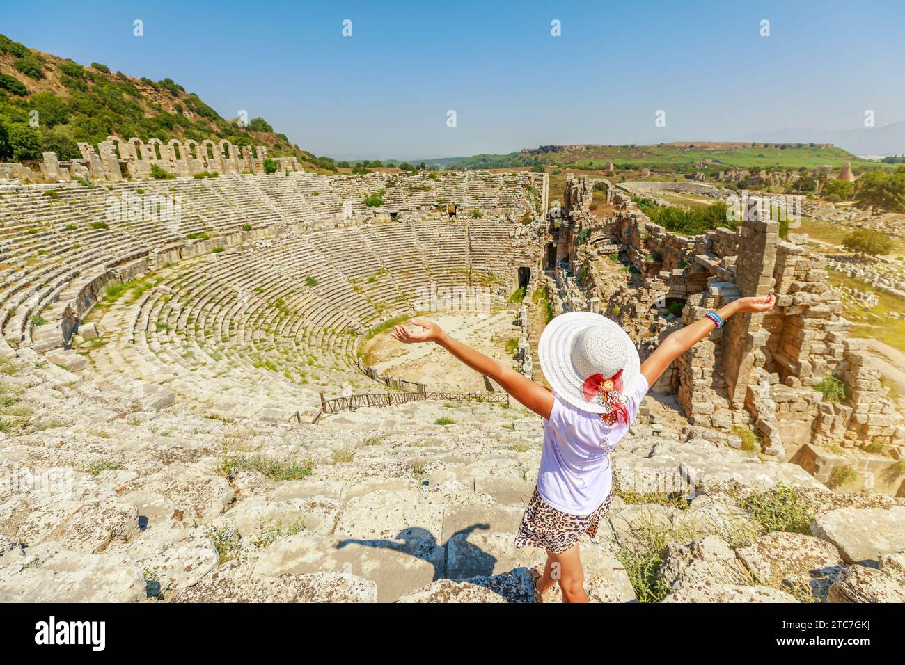 tourist woman visiting the ancient Roman Theatre in Perge, Turkey, an