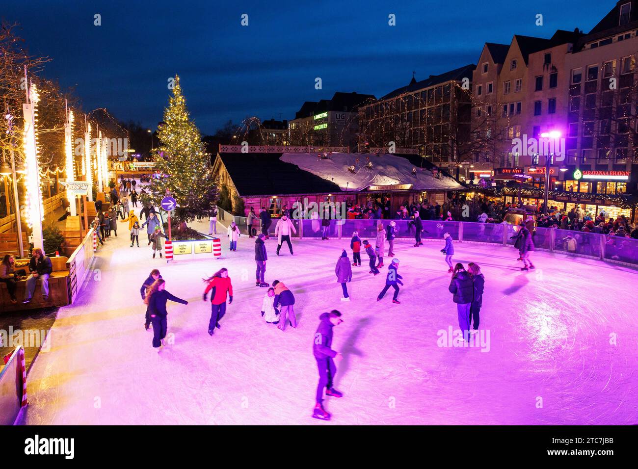 ice skating rink on the Christmas market at the Heumarkt in the historic town, Cologne, Germany. Eislaufbahn auf dem Weihnachtsmarkt am Heumarkt in de Stock Photo