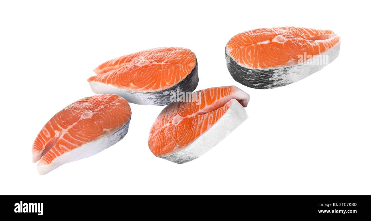 Fresh salmon steaks falling on white background Stock Photo - Alamy