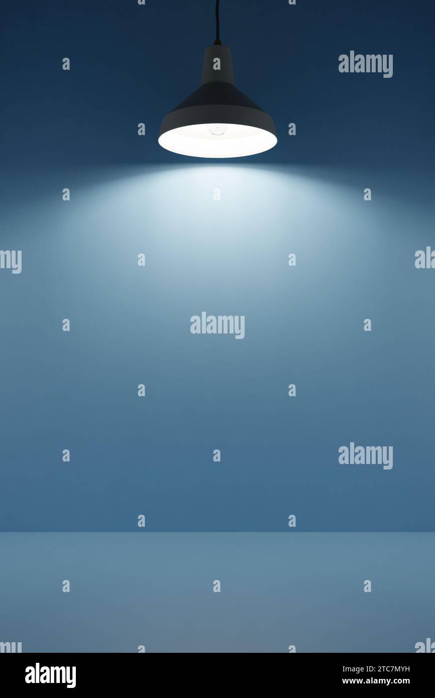 Lamp shines from above on empty podium background, interior design, free space. 3d render Stock Photo