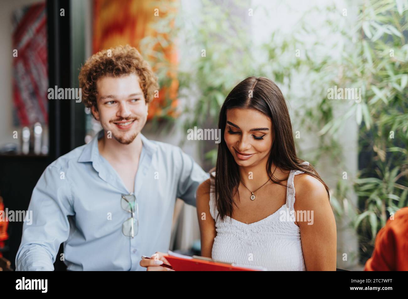 A collaborative architectural team discussing paperwork, project planning, and finances. Stock Photo