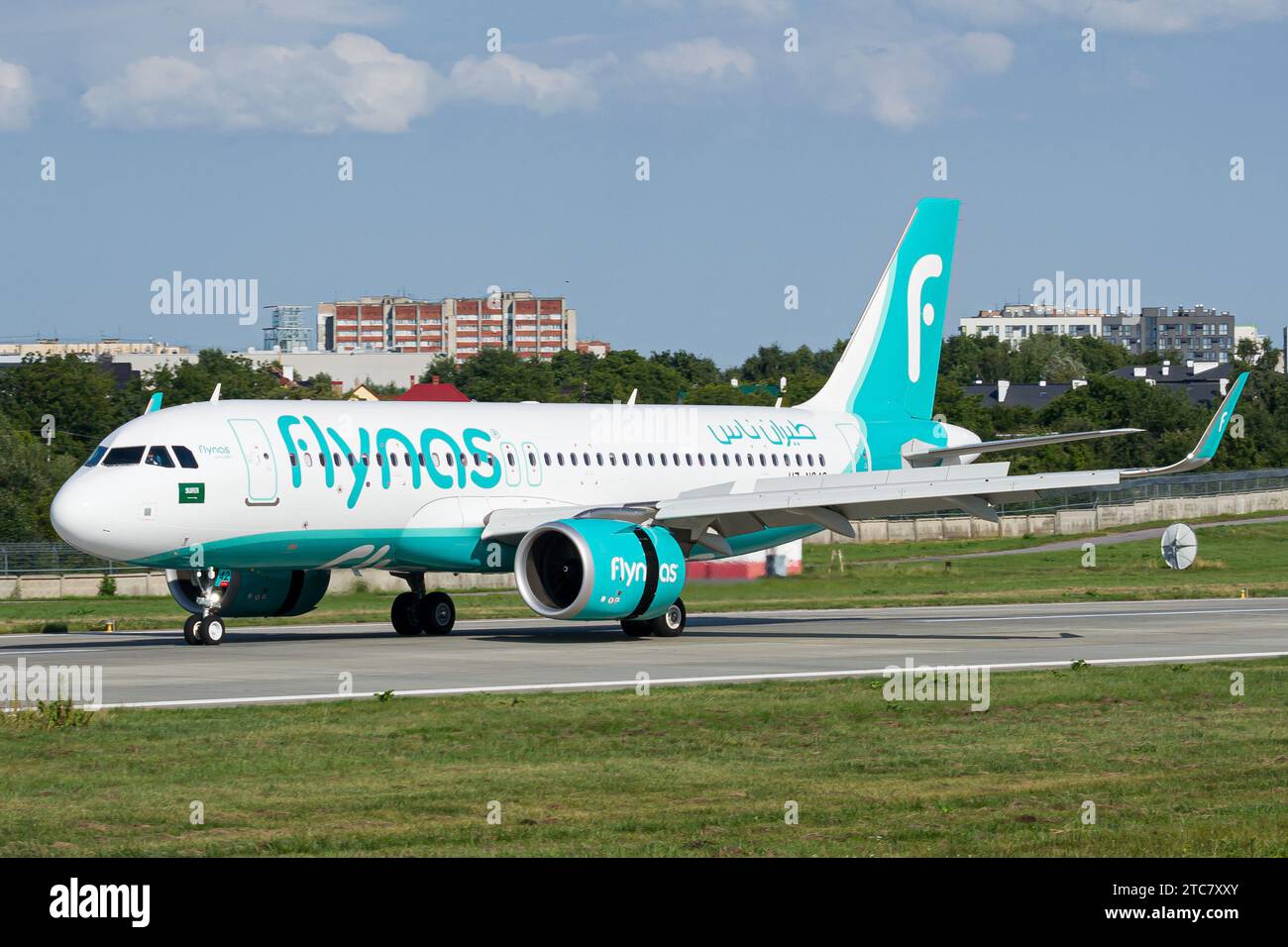 Saudi airline's Flynas Airbus A320 NEO slowing down after landing at Lviv, with reverse thrust on Stock Photo