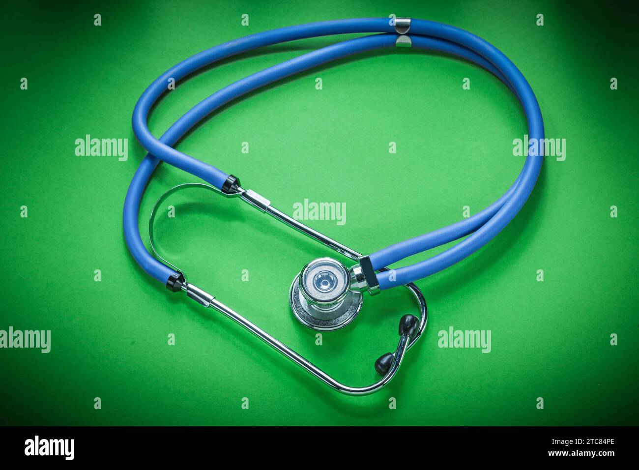 Medical stethoscope on green background Stock Photo - Alamy