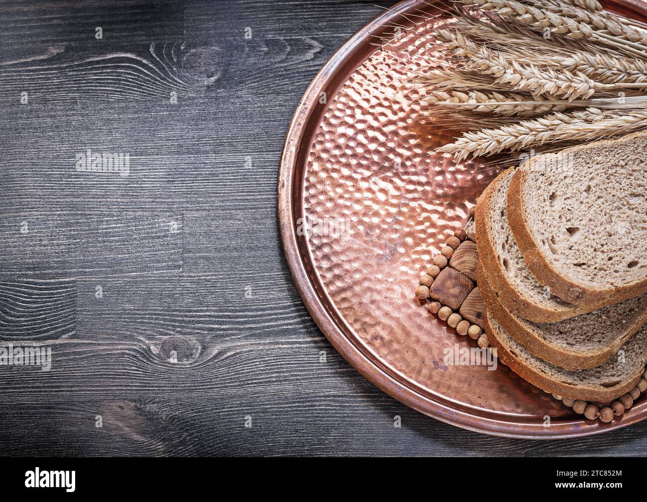 Rye wheat ears sliced loaf of bread vintage copper tray food and drink ...