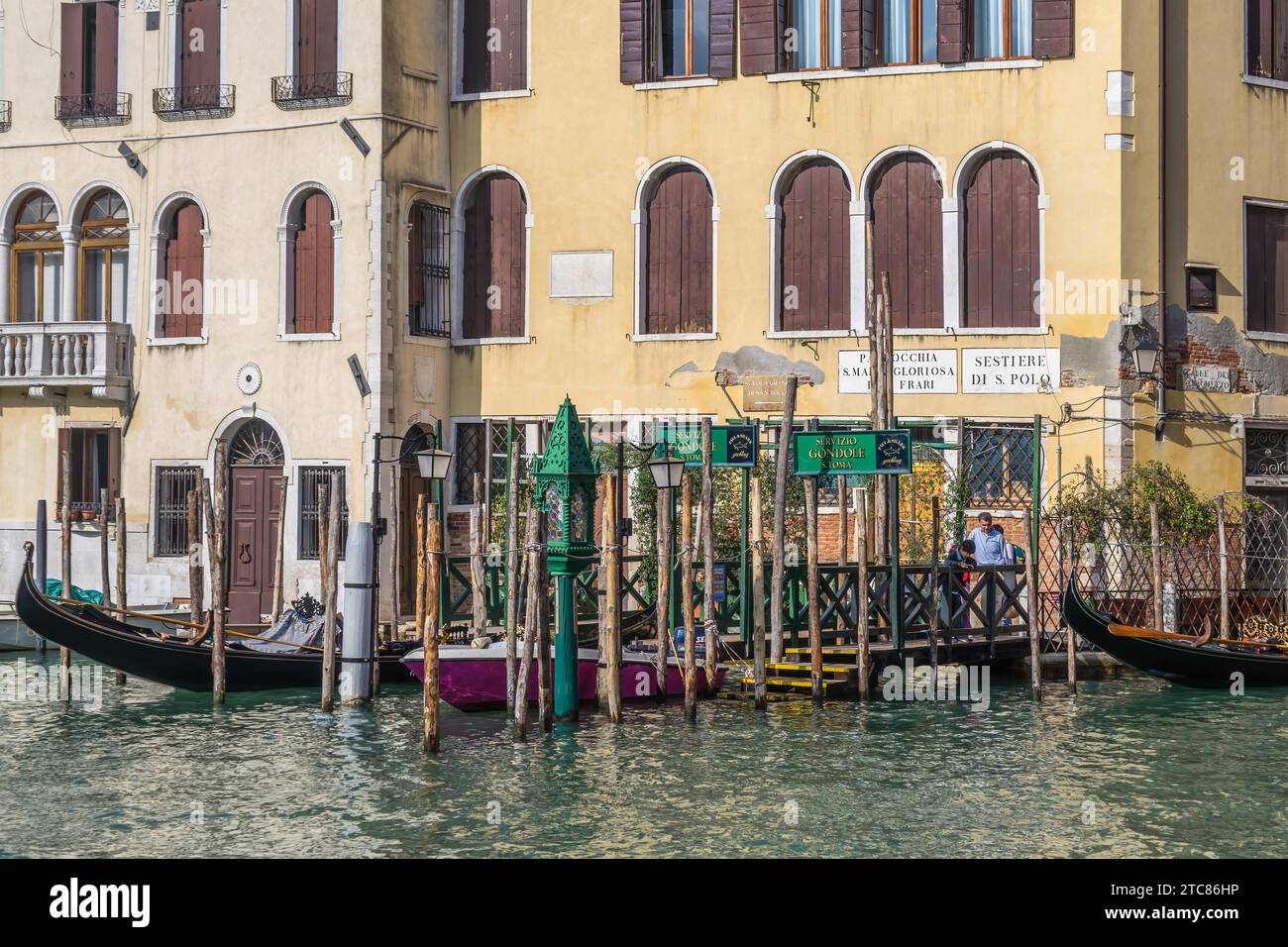 VENICE, ITALY, OCTOBER 12 : People waiting at a Gondola station in Venice on October 12, 2014. Three unidentified people Stock Photo