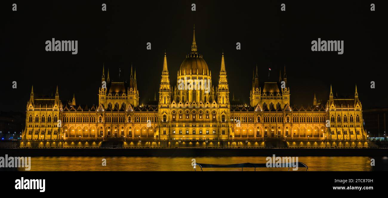 A picture of the Hungarian Parliament at night, as seen from the opposite margin of the Danube river Stock Photo