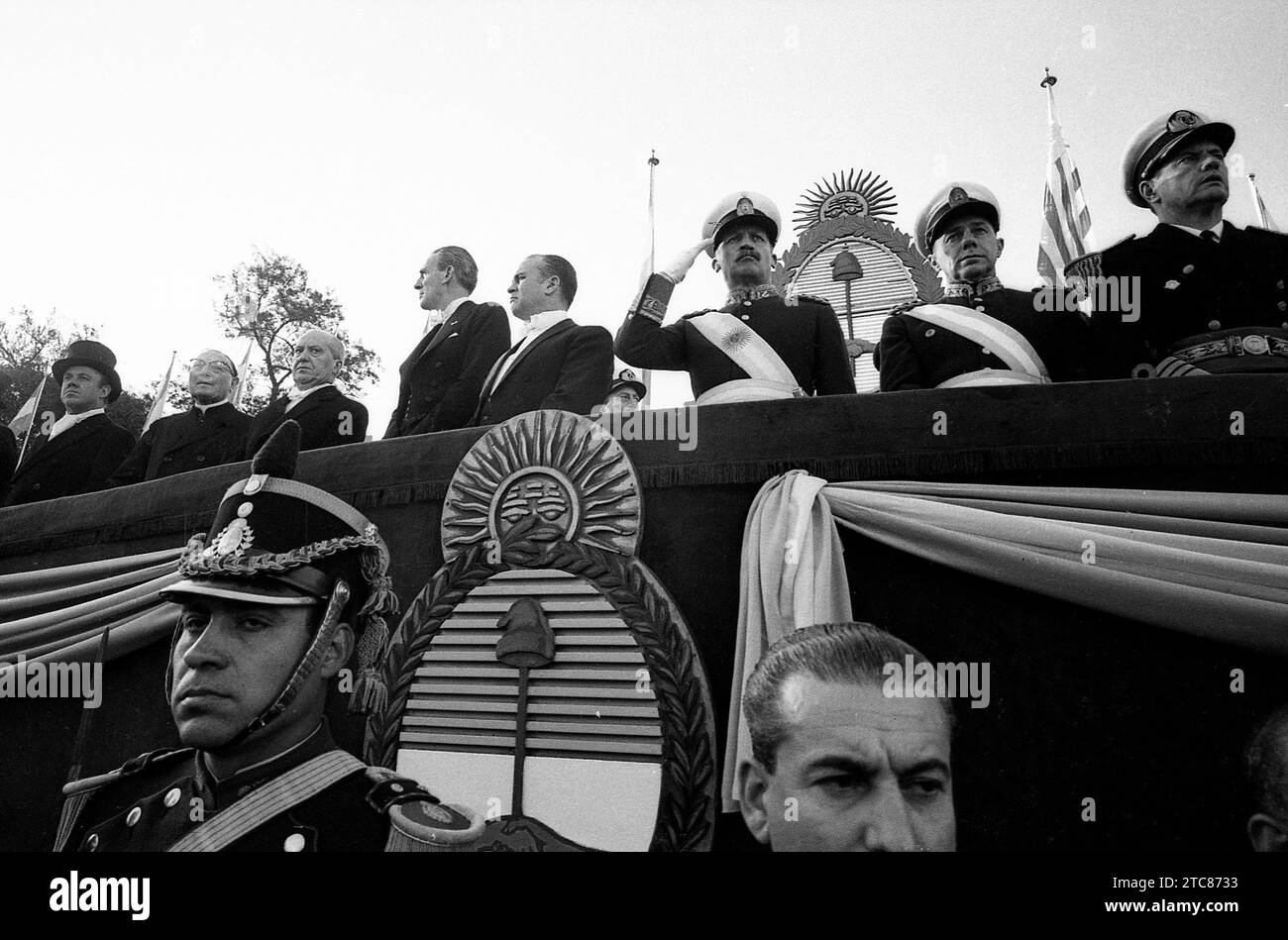 Independence Day military parade in Argentina. President General Juan Carlos Onganía (saluting, center) with General Julio Alsagaray (center right), Uruguayan President Jorge Pacheco Areco (center left), Emilio van Peborgh at Pacheco Arecos´s left, unidentified person, Cardinal Antonio Caggiano and Nicanor Costa Méndez (far left), Buenos Aires, July11, 1968. Stock Photo