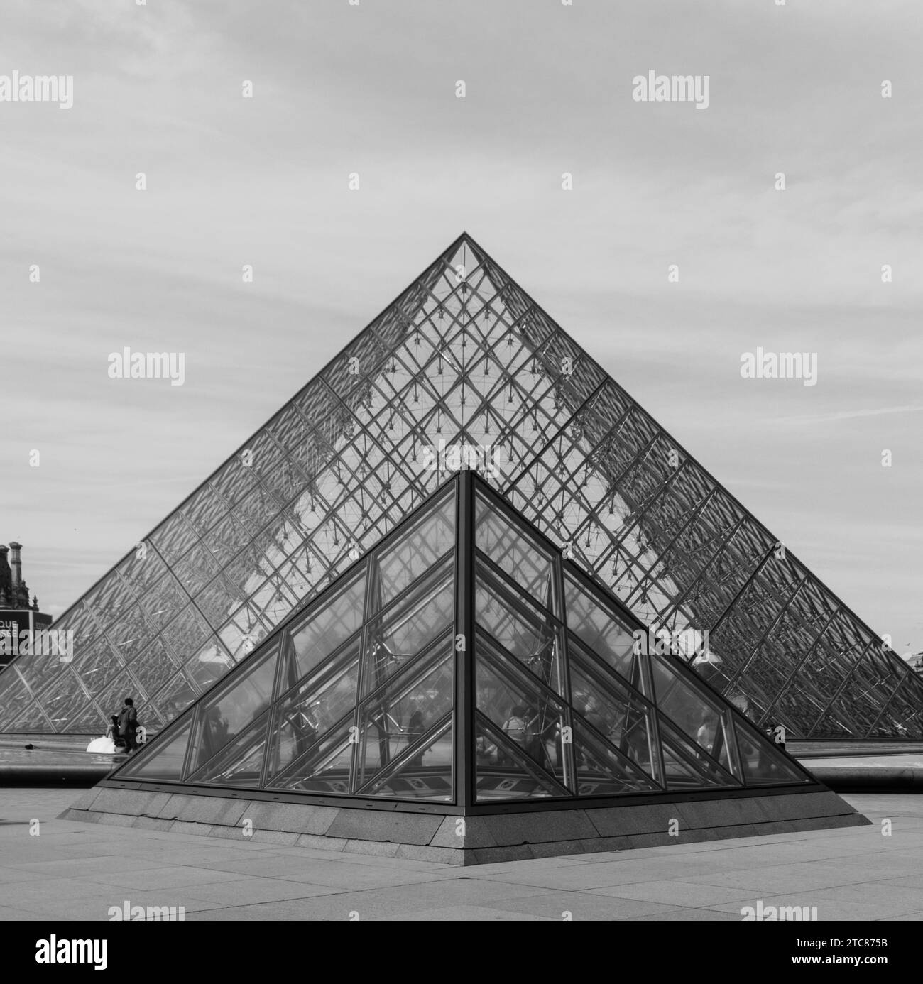 A black and white picture of the iconic pyramids outside the Louvre Stock Photo