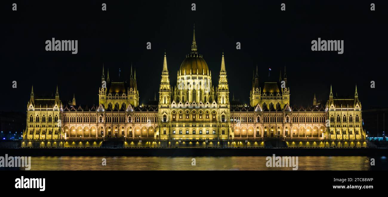 A picture of the Hungarian Parliament at night, as seen from the opposite margin of the Danube river Stock Photo