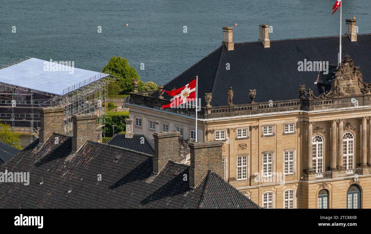 A picture of the royal Danish flag waving atop the Amalienborg complex Stock Photo