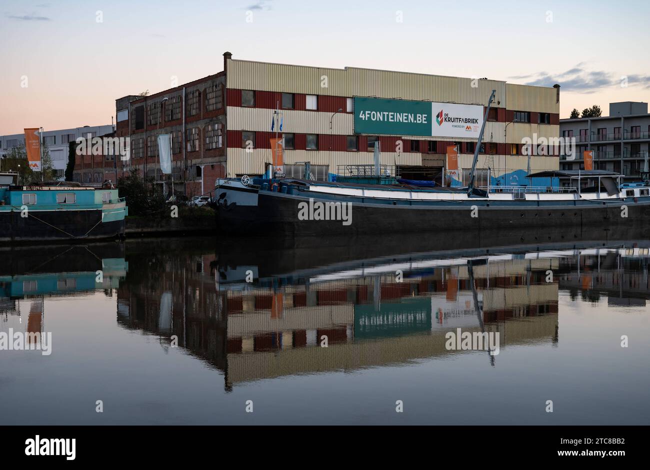 Vilvoorde, Flemish Brabant Region, Belgium, November 28, 2023 - Old industrial building called Kruitfabriek reflecting in the canal at dusk Credit: Imago/Alamy Live News Stock Photo