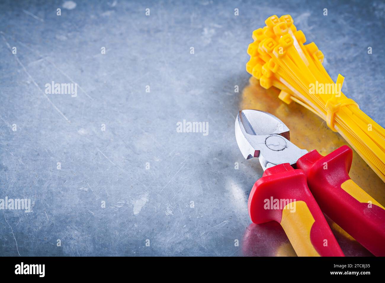 Nippers plastic self-locking cable ties on metallic background construction concept Stock Photo
