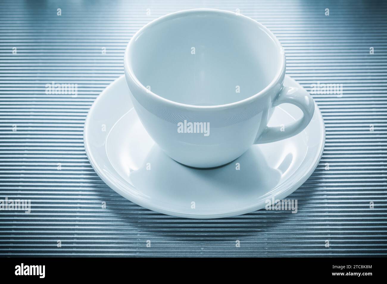 Coffee cup saucer on striped background Stock Photo
