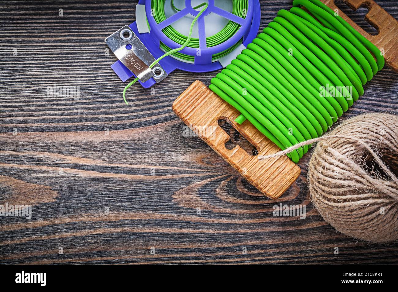 Garden tie wire hank of twine on vintage wood board gardening concept Stock Photo