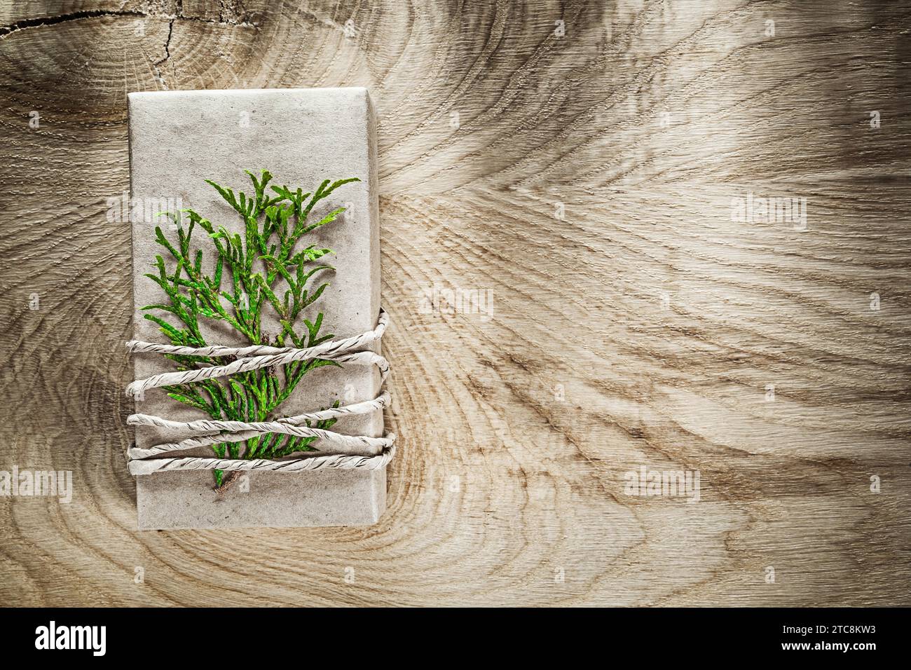 Handmade gift box with green branch on wood board Stock Photo - Alamy