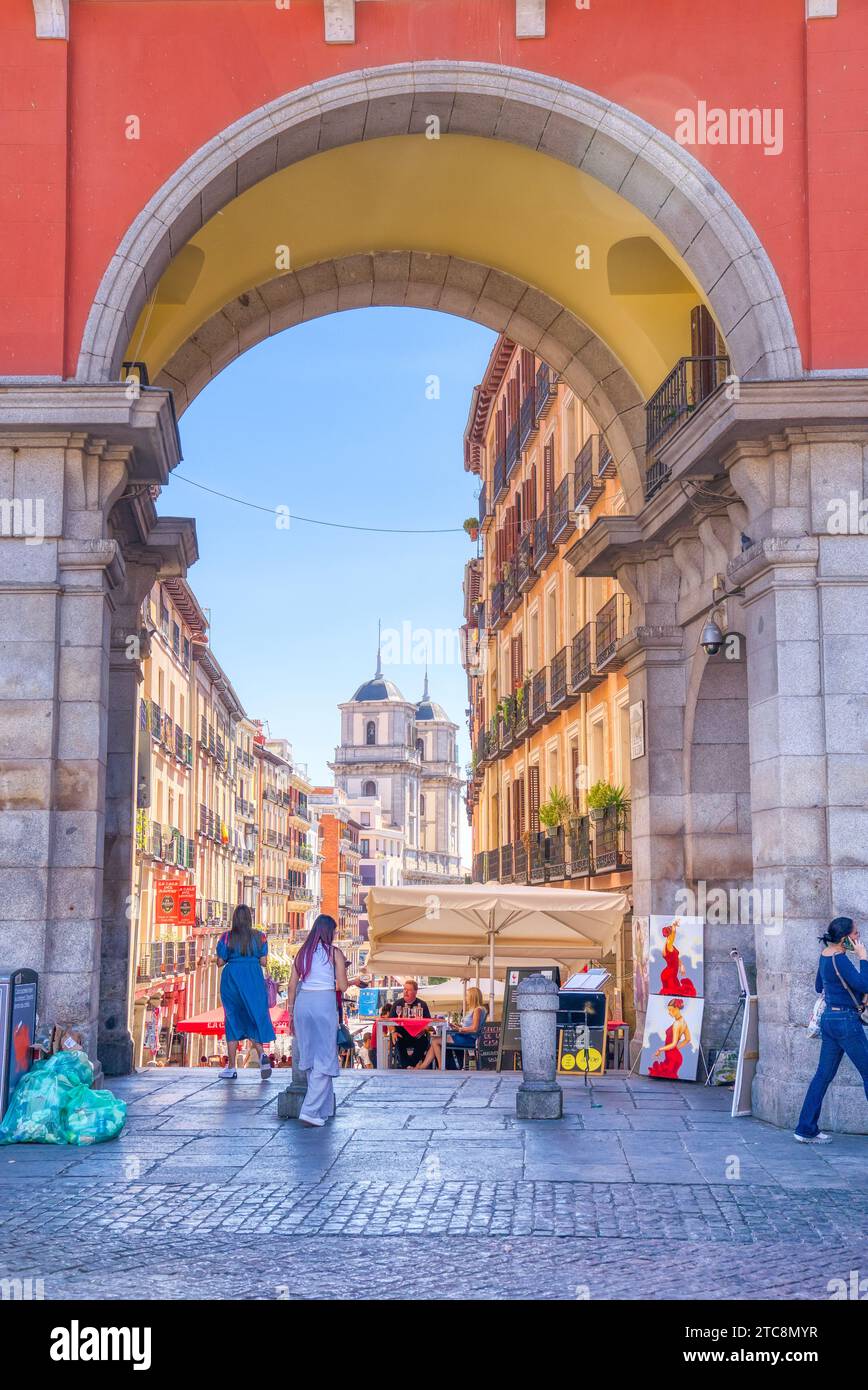 Madrid, Spain - August 28, 2023:  Exiting the historic Plaza Mayor on to the charming old streets of central Madrid Stock Photo