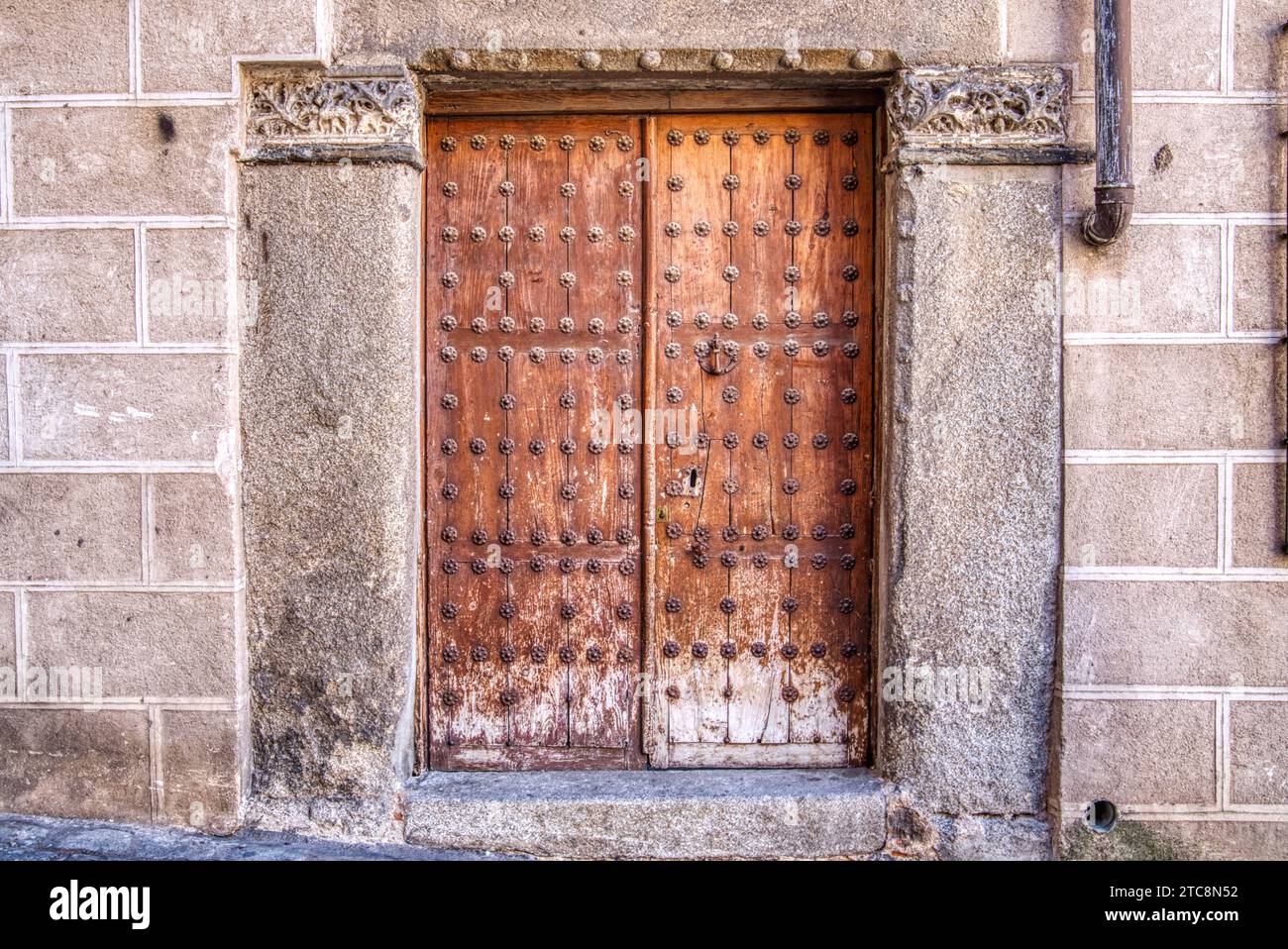 Old wooden weathered doorway in historic spain Stock Photo