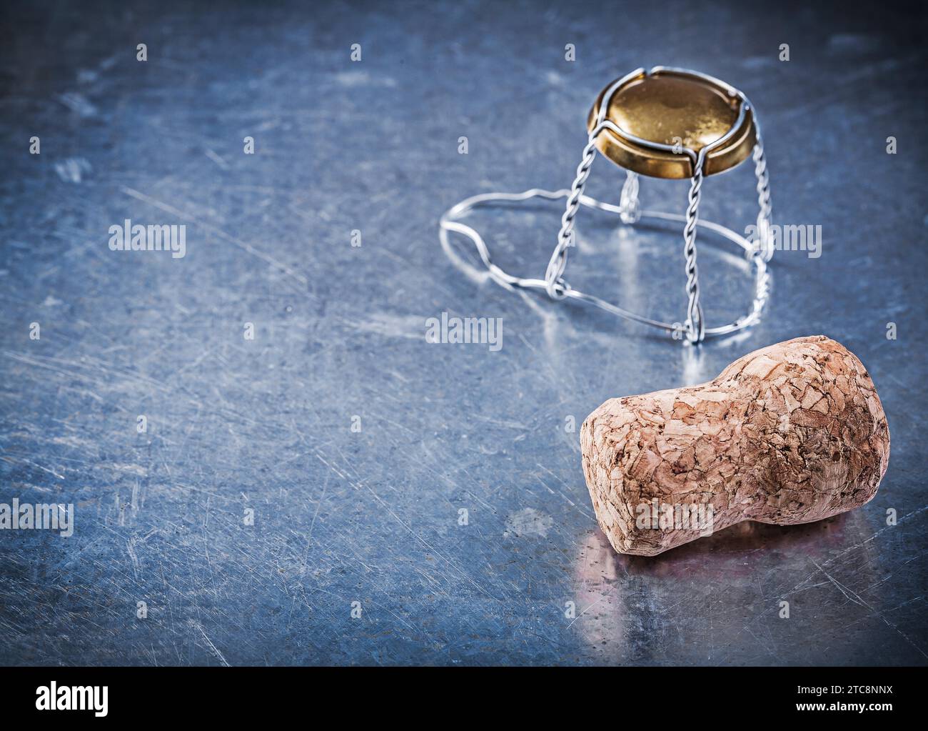 Cork stopper with twisted wire on scratched metallic background Stock Photo
