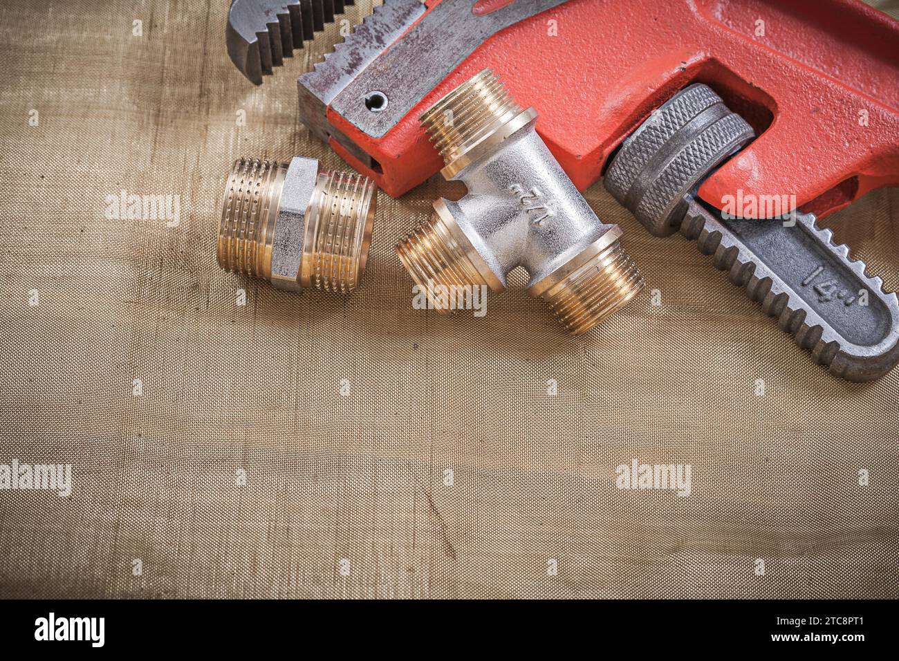 Monkey wrench pipe fittings on mesh filter grid Stock Photo - Alamy