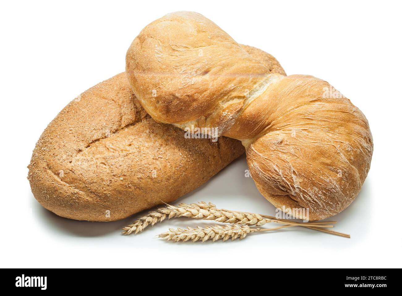 Two loaves of bread and ears of wheat against a white background Stock ...