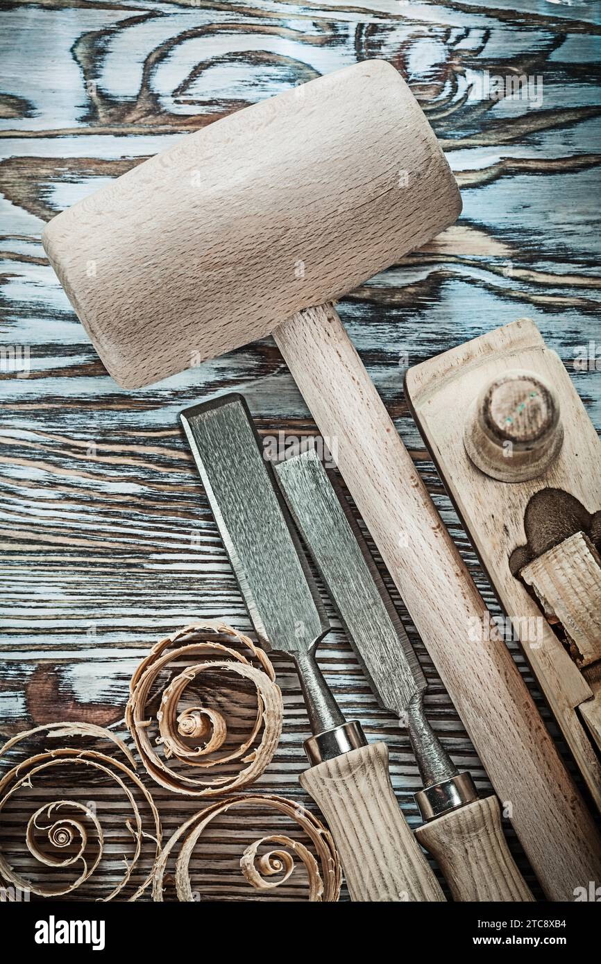 Block Hammer Chisel Plane Wood shavings on wooden board Stock Photo