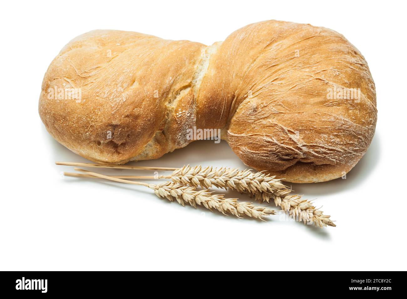 Loaf of sweet bread and ears of wheat against a white background Stock ...