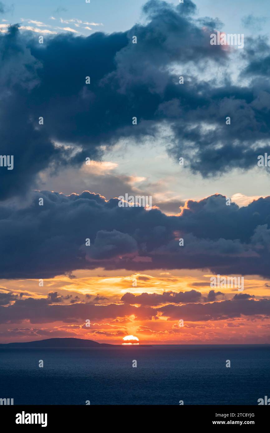 Dramatic cloudy sky at sunrise over the sea, Aegean Sea, Syros, Cyclades, Greece Stock Photo