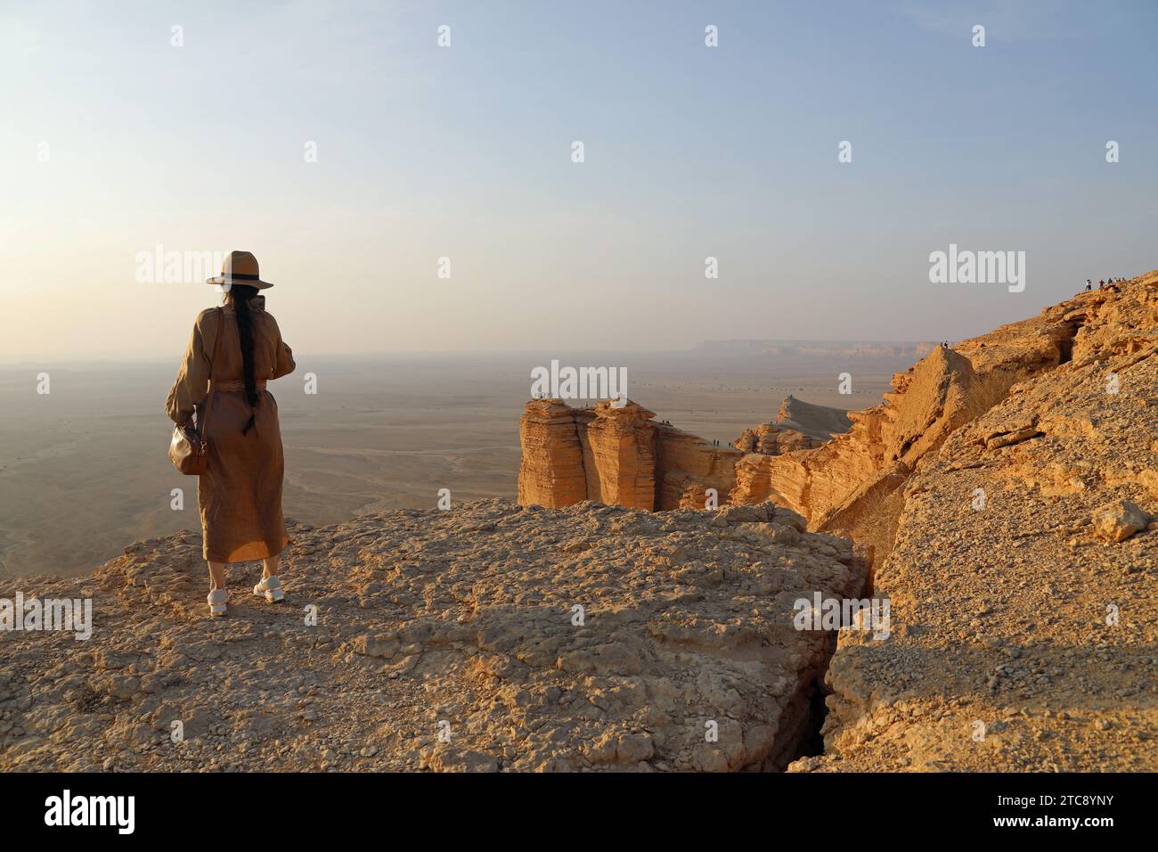 Tourist standing on the Edge of the World in Saudi Arabia Stock Photo