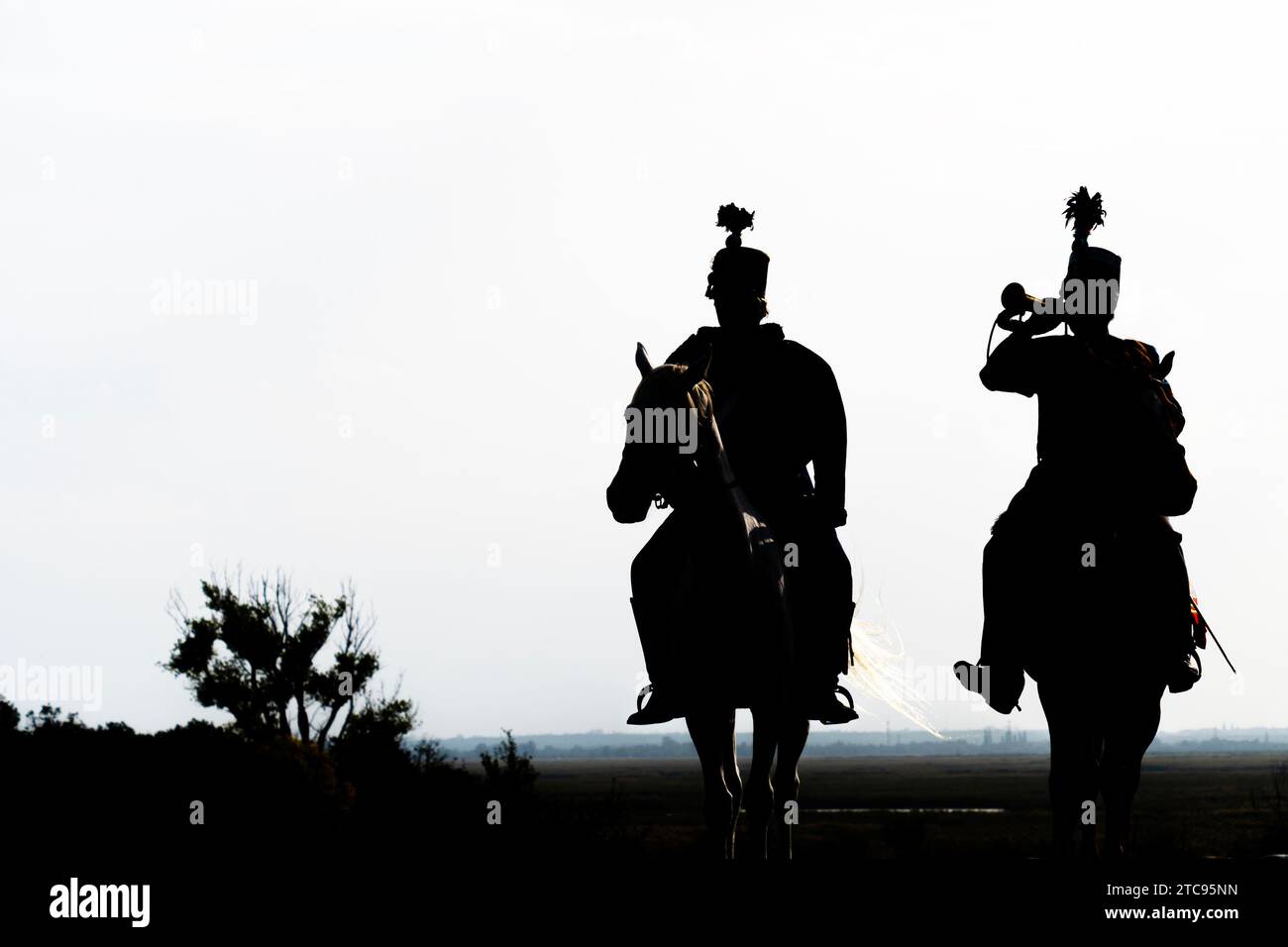 Silhouette of two hungarian hussars on horseback at dusk Stock Photo