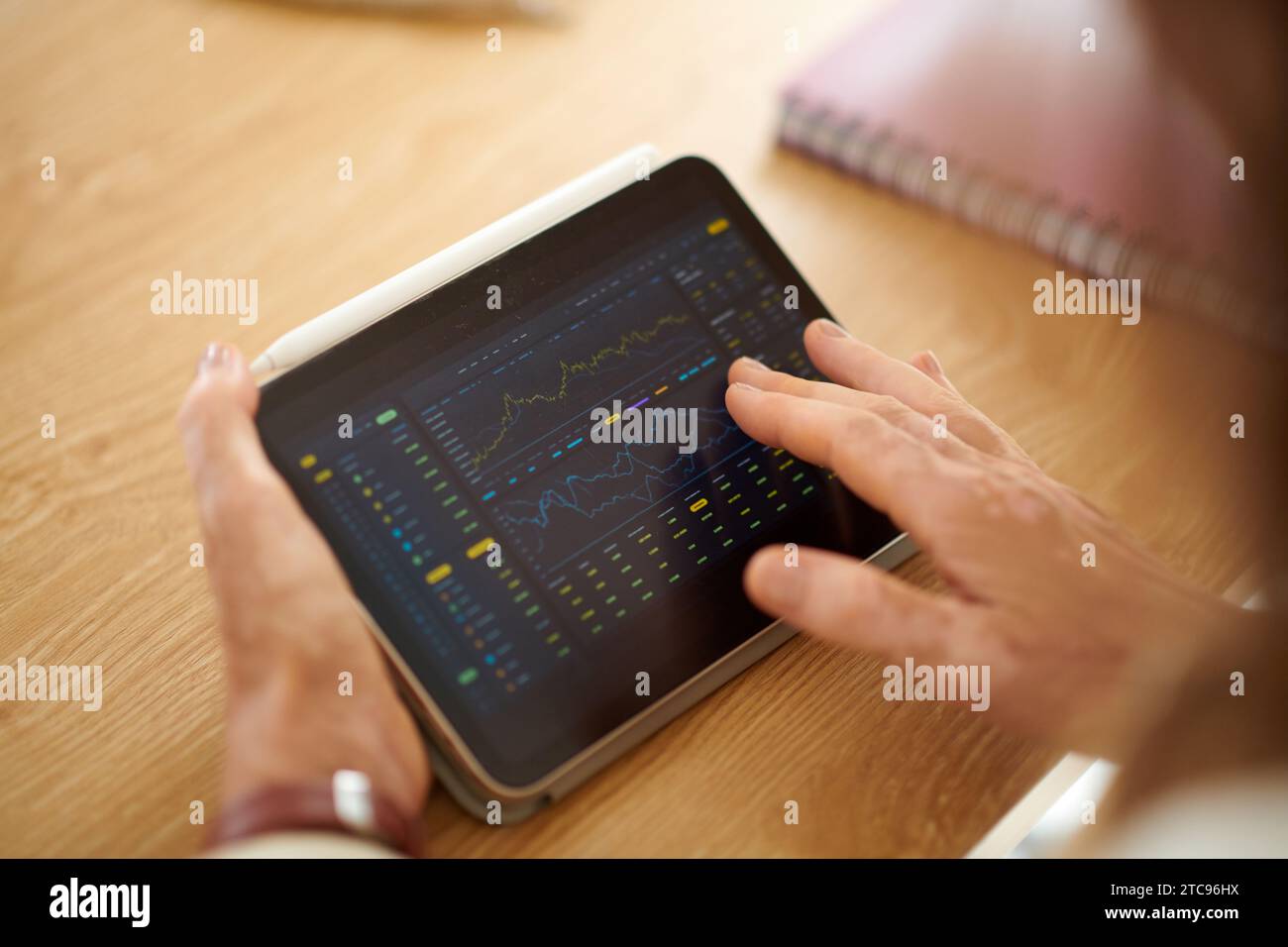 Closeup image of businesswoman analyzing trading data on tablet screen Stock Photo