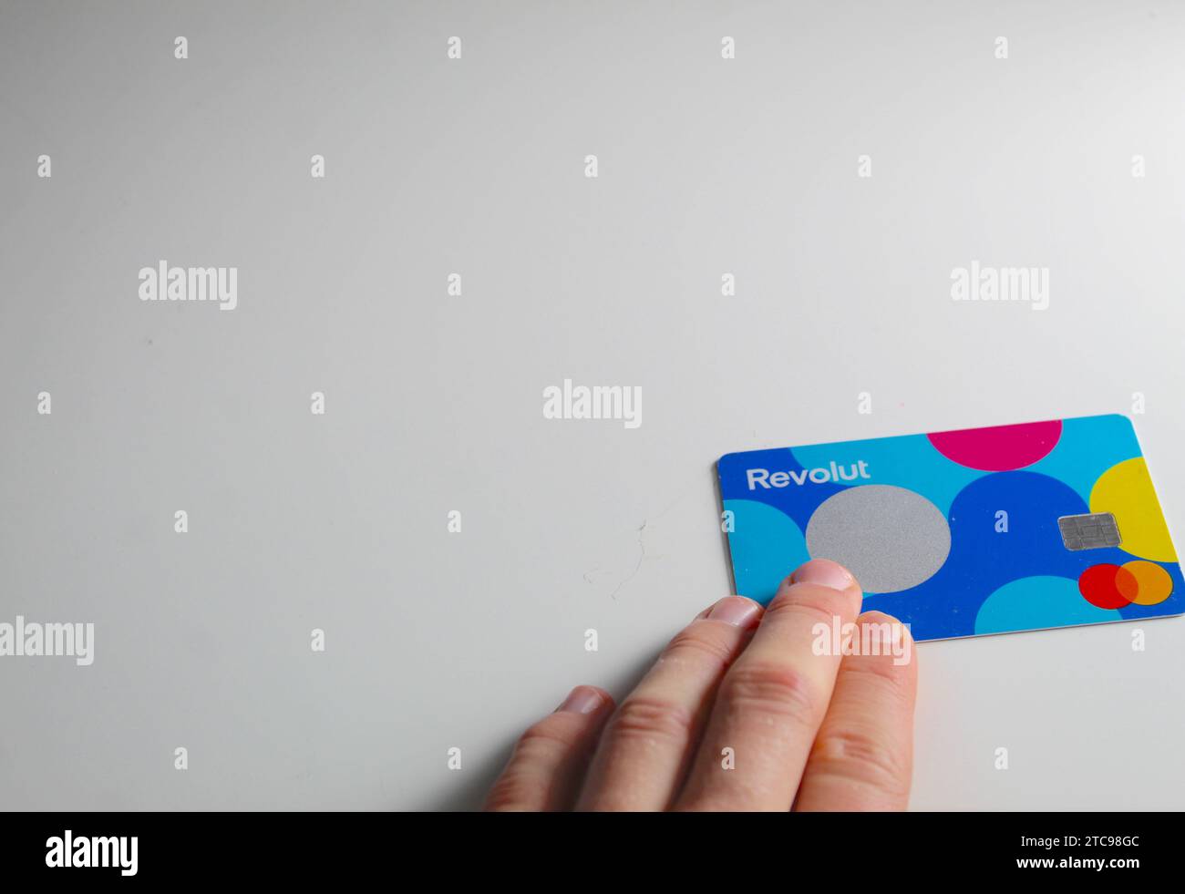 A close up photo of the Revolut Junior bank card on a white background. Stock Photo