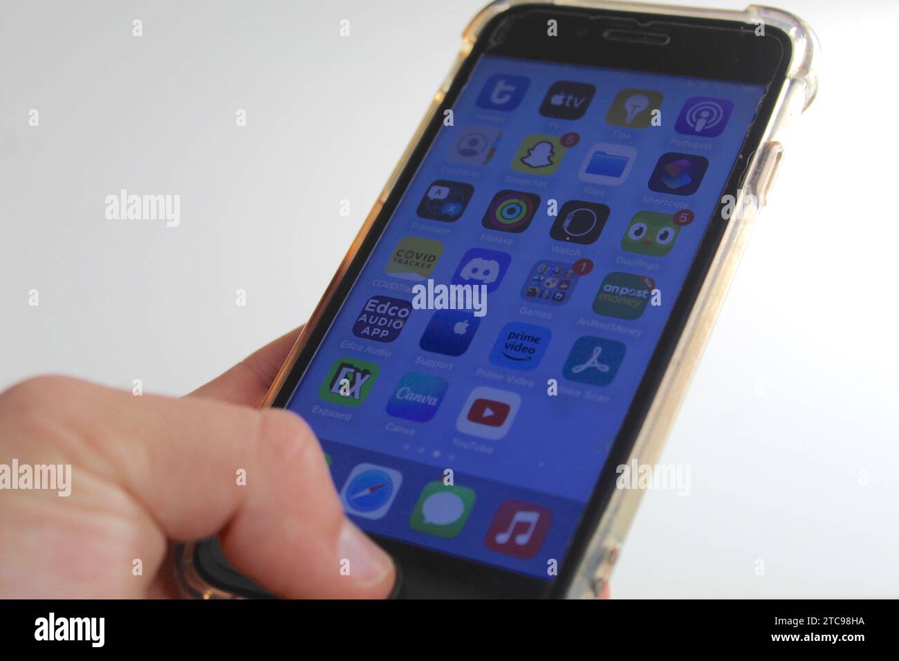 A close up photo of someone scrolling on the apps on their iPhone