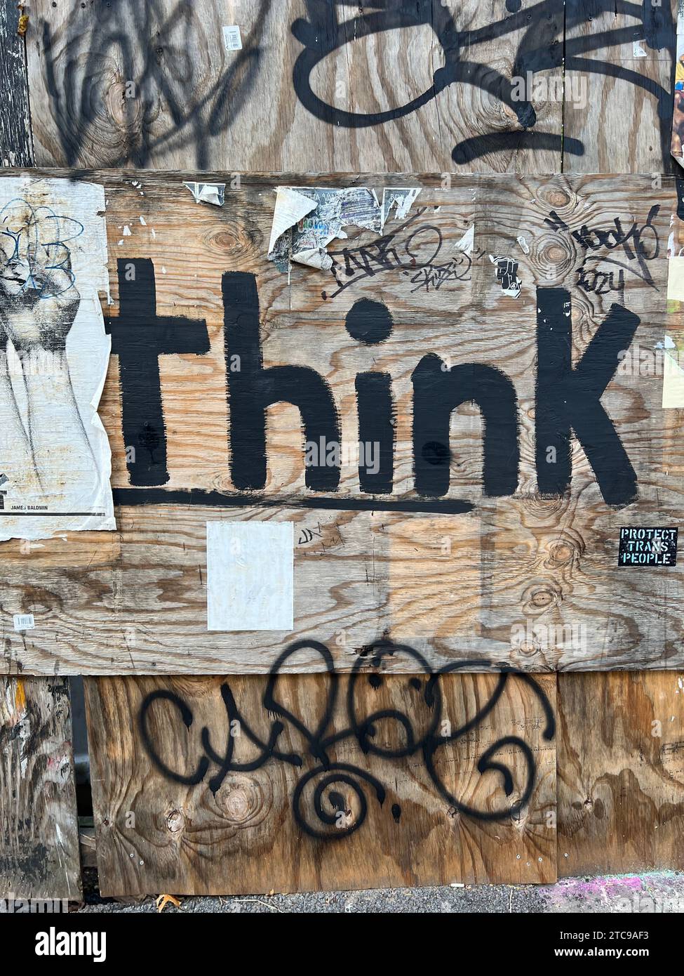 Writing on a construction wall reminding us to use our minds in the Fort Greene neighborhood of Brooklyn, New York. Stock Photo