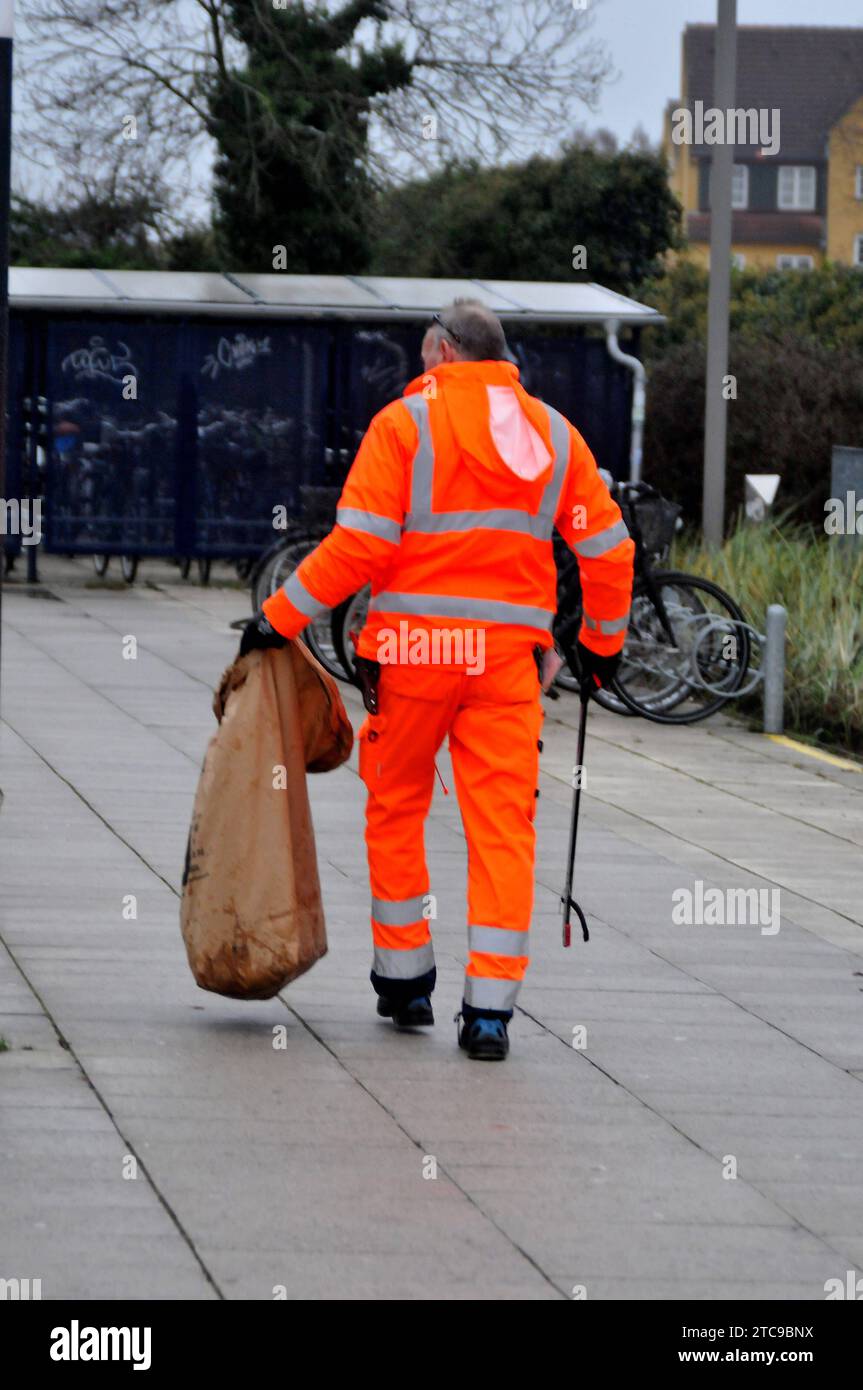 Copenhagen, Denmark /11 December 2023/.Male worker picking up left over