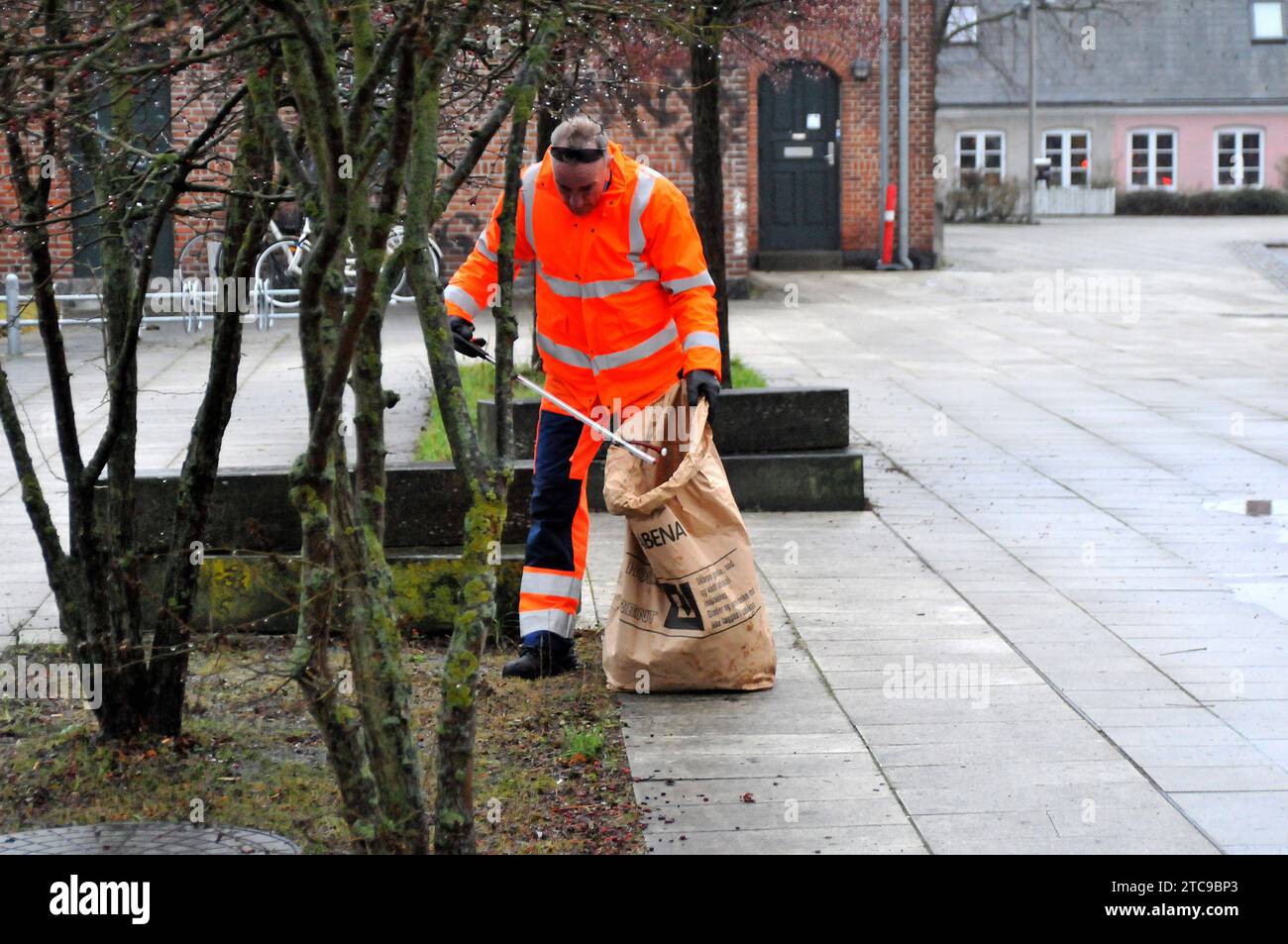 Copenhagen, Denmark /11 December 2023/.Male worker picking up left over