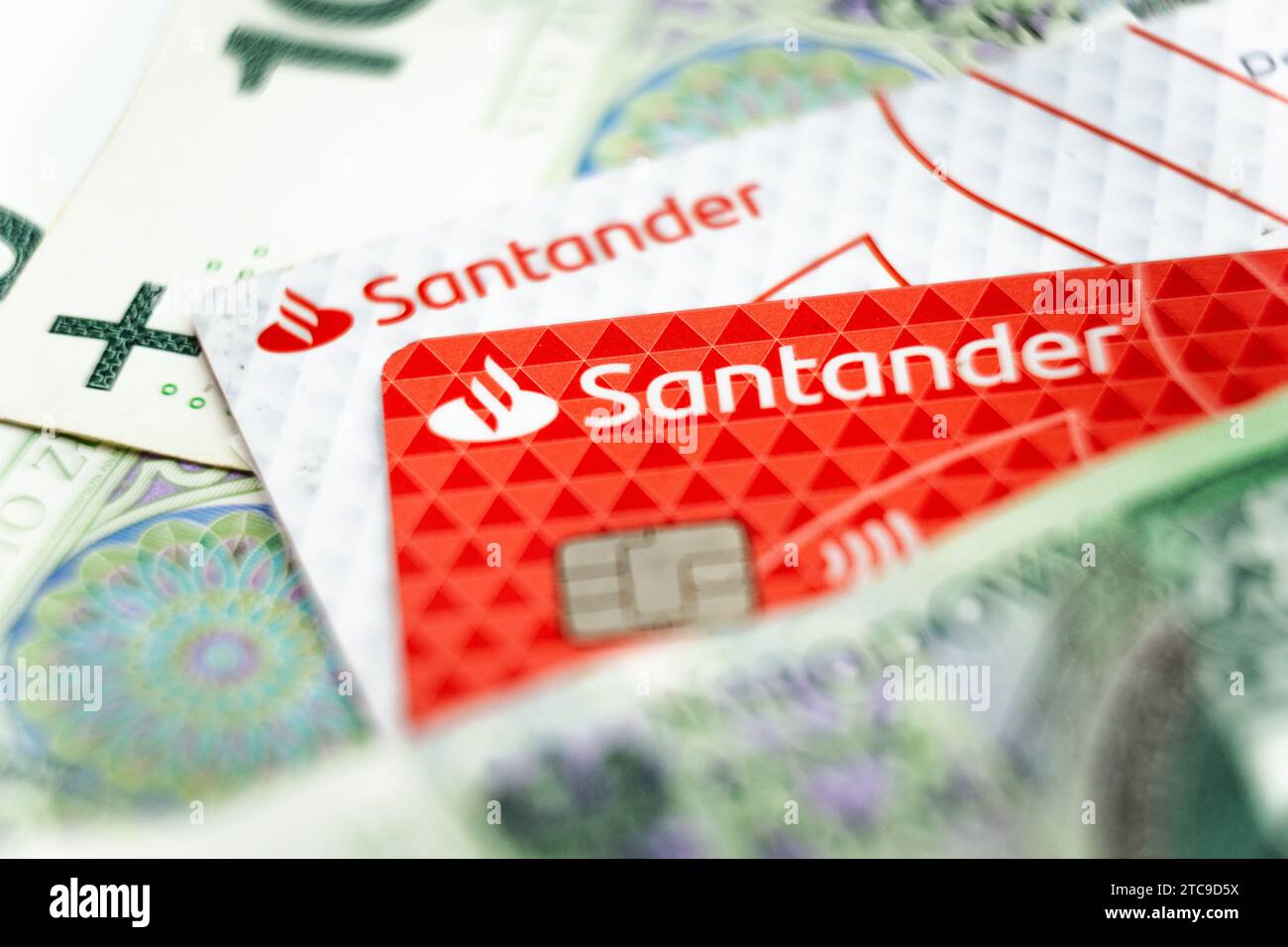 wałbrzych, poland - 11.12.2023: Santander Bank Polska SA logo on a credit card among Polish zloty banknotes Stock Photo