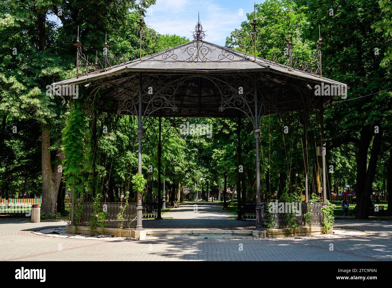 Beautiful metallic garden pavilion in Alexandru Buia Botanical Garden from Craiova in Dolj county, Romania, in a spring day with white clouds Stock Photo