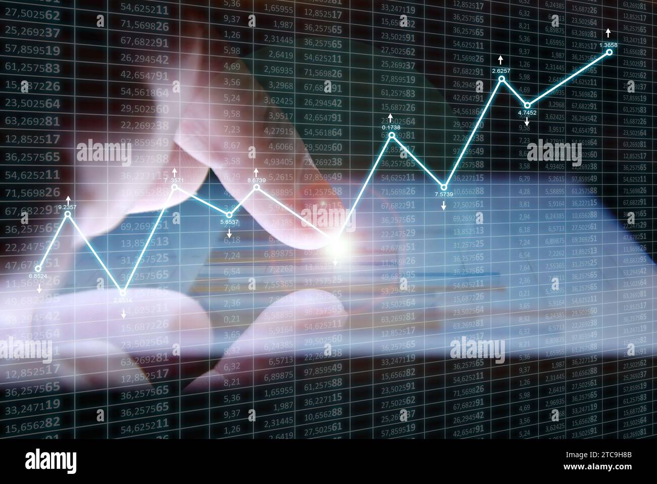 Hand touching digital tablet screen with growth of financial stock ...