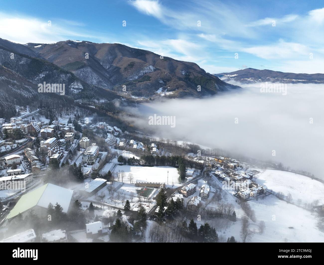 An idyllic aerial view of a quaint mountain town nestled among lush ...